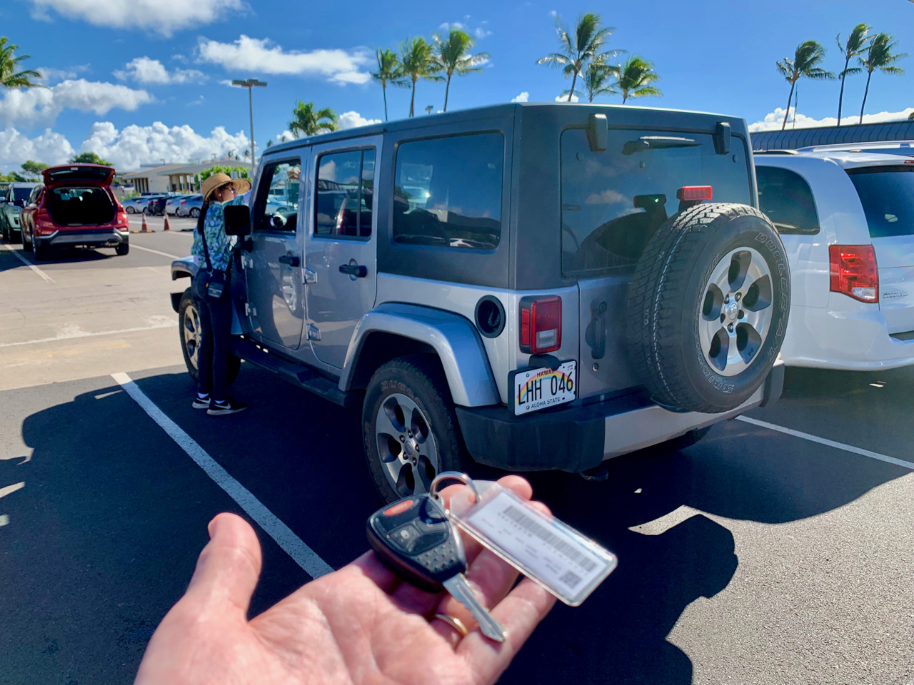 Customer at car rental lot with a key